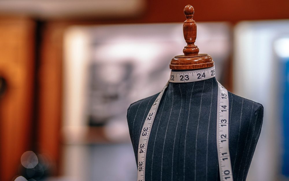 Pinstripe suit on a tailor's form with a measuring tape